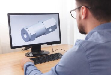 Engineer, Constructor, Designer in Glasses Working on a Personal Computer. He is Creating, Designing a New 3D Model of Mechanical Component in CAD Program. Freelance Work, LOS ANGELES, CALIFORNIA - 25.10.2019