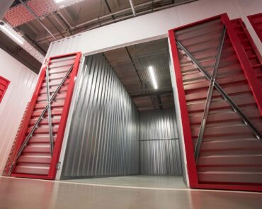 Empty unit of self-storage facility with lamp on ceiling