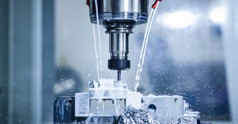 Close up of CNC machine cutting metal.