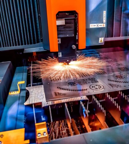 CNC Laser cutting of metal, modern industrial technology. Small depth of field. Warning - authentic shooting in challenging conditions.