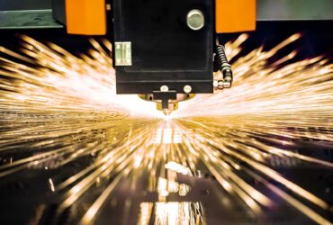CNC Laser cutting of metal, modern industrial technology. Small depth of field. Warning - authentic shooting in challenging conditions.