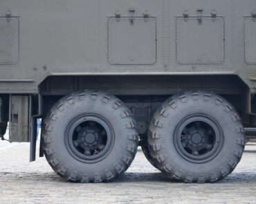 Close up view of green military truck. Modern military transportation vehicle technologies
